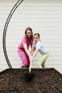 Dr. Kate Castle and her daughter, Abby (11) tending to their backyard garden